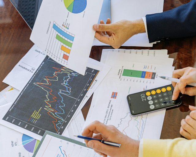 Senior fund managers conducting intensive late-night due diligence on investment data using a tablet.