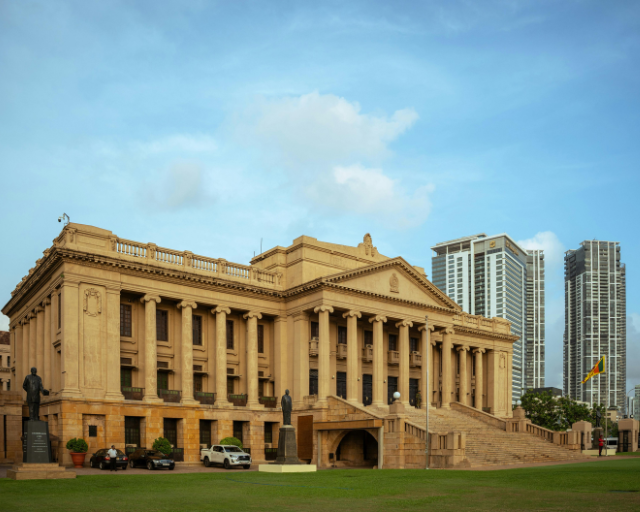 Investment team in a boardroom with a world map, planning global and regional strategies for the Sri Lanka Opportunity Fund.